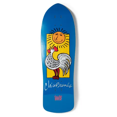 Chocolate Brenes Retro (Signed) skateboard deck: White rooster with a red comb crowing under a smiling sun with rays, set in a yellow rectangle on a blue old-school shaped deck. A white signature runs across the lower part with the brand logo at the tail.