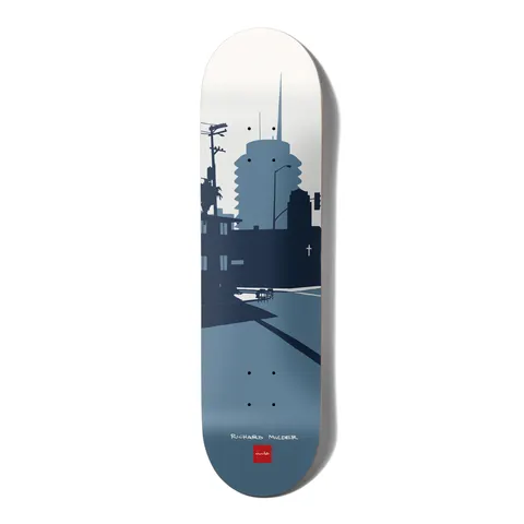 Chocolate Mulder Original City skateboard deck: Flat blue-grey silhouette illustration of a Los Angeles street scene with a round tower, telephone pole, palm tree and shadows, fading from white sky to slate blue. Rider name and Chocolate logo at the tail.