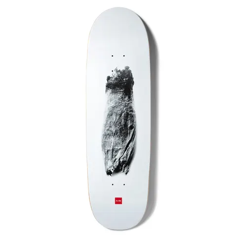Chocolate Tershy Zorched Couch skateboard deck: Grainy black and white photograph of a scorched, charred couch or armchair shape centred on a plain white deck, with the small red Chocolate logo near the tail.
