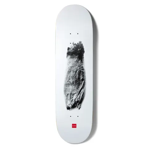Chocolate Tershy Zorched skateboard deck: Grainy black and white photograph of a charred, scorched object resembling a burnt bundle, centred on a plain white deck with the small red Chocolate logo near the tail.
