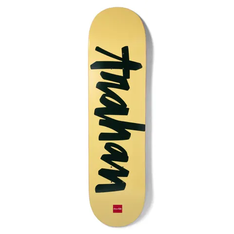 Chocolate Trahan OG Chunk skateboard deck: Rider's name 'trahan' in large black brush-script lettering running up the deck on a pale yellow background.