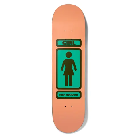 Girl McCrank 93 Til Pop Secret skateboard deck: Girl brand's classic figure logo in a rounded rectangle frame, dark brown outline and figure on a teal panel, with GIRL banner above and rider name banner below, all on a flat peach deck.