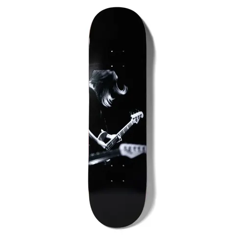 Girl Spike Photo Kim Gordon skateboard deck: A black and white live-music photograph of a long-haired musician bent over a bass guitar, with another guitar neck blurred in the foreground. Dark, moody image on a black deck.
