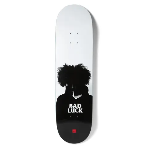 Chocolate Aikens Bad Luck skateboard deck: Black and white photographic silhouette of a person with a large curly afro and a cigarette in the mouth, face in shadow. BAD LUCK is printed in white on the dark chest, with a small red Chocolate logo at the bottom.
