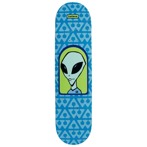 Alien Workshop Believe Pattern skateboard deck: Grey alien head with large black eyes in a lime green arched frame on a blue deck patterned with a repeating pale blue triangular logo, with a small 'believe.' label at the top.
