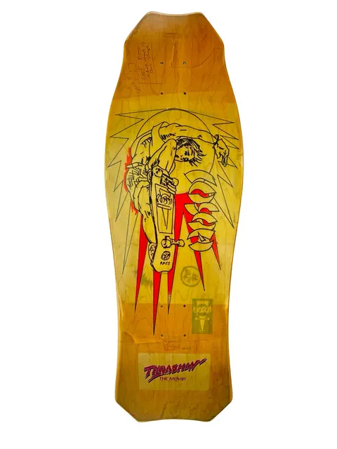 Hosoi Sketch Air skateboard deck: Black line drawing of a skater grabbing a board in a backflipping air, framed by spiky rays and red bolt shapes, on a yellow-stained shaped deck. A Thrashin' The Movie sticker sits near the tail, and there are signatures at the nose.