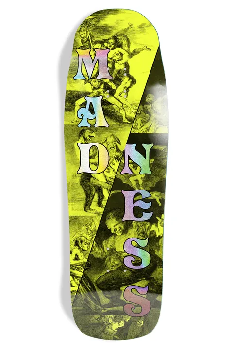 Madness Split skateboard deck: Shaped deck split diagonally into a yellow-tinted and a dark half, both printed with engraved scenes of writhing grotesque figures. The word Madness is stacked down the board in psychedelic holographic lettering.