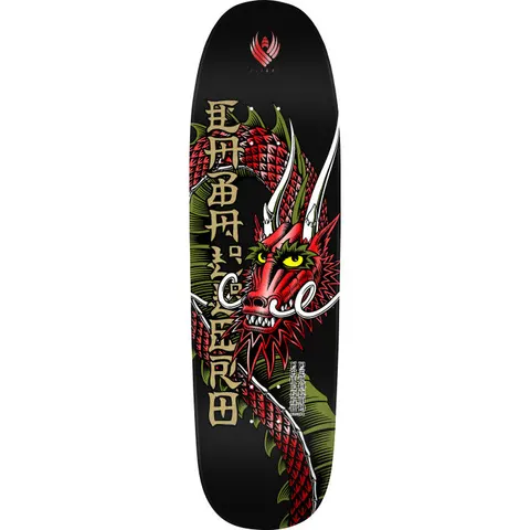 Powell Peralta Caballero Ban This Black Red Foil Flight skateboard deck: A red scaled dragon with yellow eyes, white horns and green frills coils down a black deck. Gold Japanese-style characters run vertically beside it, with a small red winged emblem at the top.