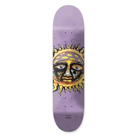 Primitive x Sublime Rise skateboard deck: The Sublime sun face logo in yellow and orange, with eyes, one holding a skull, and small symbols within the features, on a mottled lilac deck. Small Sublime and Primitive text beneath.
