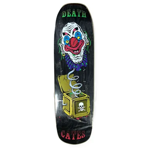 Death Skateboards Death Benson Devil Woman skateboard deck: Grinning clown head with a red nose and blue ruffled collar on a coiled spring, bursting out of an open yellow jack-in-the-box marked with a skull and crossbones. Black stained deck with Death and Cates in circus-style lettering.