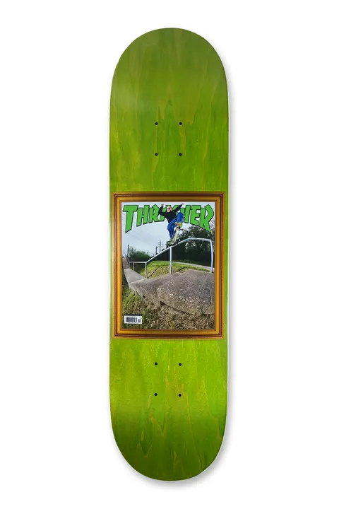 Deathwish Foy Commemorative Hammer 8.5 skateboard deck: A framed Thrasher magazine cover showing a skater in mid-air over a handrail beside a stone ledge, with a barcode on the cover. The frame is gold-brown on a green stained deck.