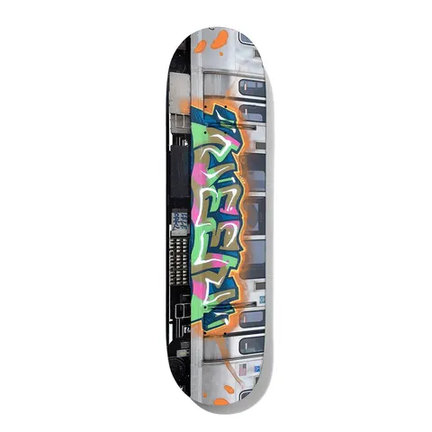 Deathwish Neen L Train 8.0 skateboard deck: Photograph of the side of a silver subway train with a large graffiti piece in green, pink, blue and gold bubble lettering outlined in orange, with windows and doors behind.