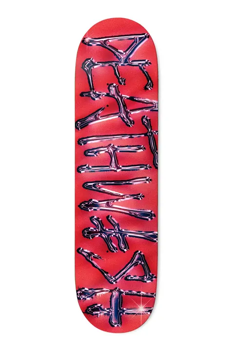 Deathwish OG Spray Chrome RED 8.38 skateboard deck: Deathwish name in large vertical brush lettering rendered as shiny airbrushed chrome with sparkle highlights, on a red-pink sprayed background.