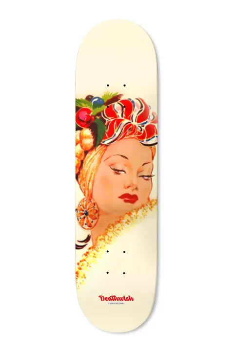 Deathwish Yuri Bonito 8.38 skateboard deck: A vintage-style painted portrait of a woman with half-closed eyes and red lips, wearing a fruit-topped headwrap, large earring and ruffled collar, on a cream background with a small red Deathwish logo.