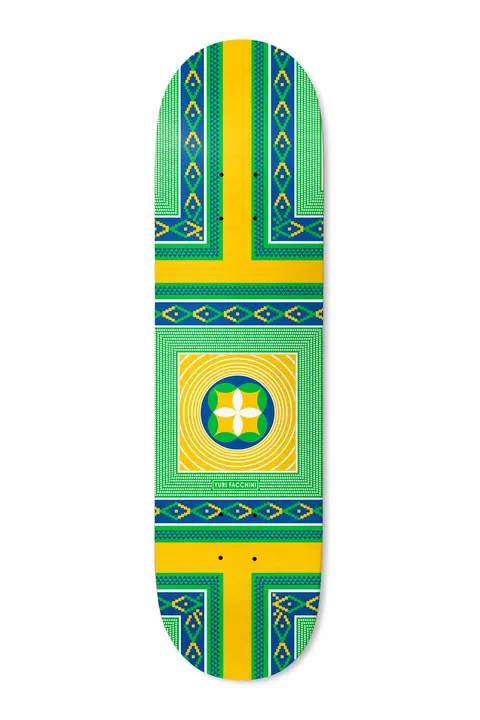 Deathwish Yuri Estilo 8.25 skateboard deck: A symmetrical geometric pattern of green, blue and yellow woven-style borders and a cross of yellow bands, with a circular floral emblem inside concentric squares at the centre.