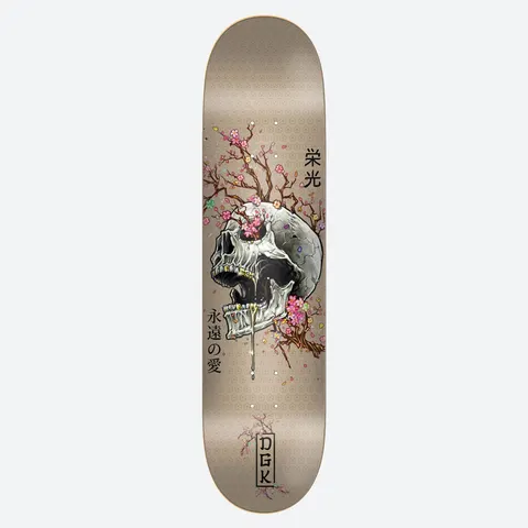 DGK Ancestry 8.25 skateboard deck: A cracked white skull with gold teeth is wreathed in pink cherry blossom branches on a tan deck with a faint floral pattern, with Japanese characters beside it and a boxed DGK logo at the tail.