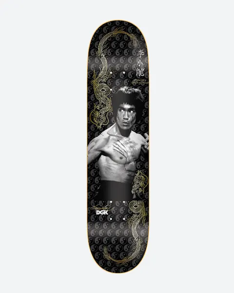 DGK x Bruce Lee Balance Embossed skateboard deck: Black and white photographic portrait of a bare-chested martial artist with claw marks across his chest, flanked by gold dragons and Chinese characters, over a repeating grey yin-yang pattern on black.