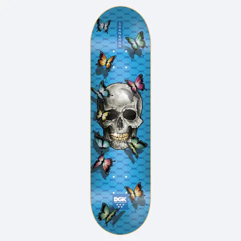 DGK Dead Poet Shanahan 8.25 skateboard deck: Realistic grey skull with gold teeth surrounded by colourful butterflies, on a blue deck with a repeating DGK pattern. Vertical Shanahan name tag at the nose and DGK logo at the tail.
