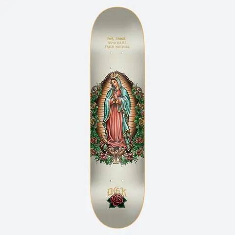 DGK Grace Cream 8.06 skateboard deck: Cream deck with a tattoo-style illustration of Our Lady of Guadalupe in a red robe and teal mantle, with golden rays, roses and a cherub at her feet. Gold blackletter text above and DGK with a red rose below.