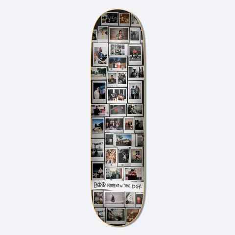 DGK Moments Boo 8.25 skateboard deck: A dense grid of instant-film snapshots covering the whole deck, showing people, street scenes and skating in varied colours. A torn white strip near the bottom carries the hand-drawn caption with a peace sign.
