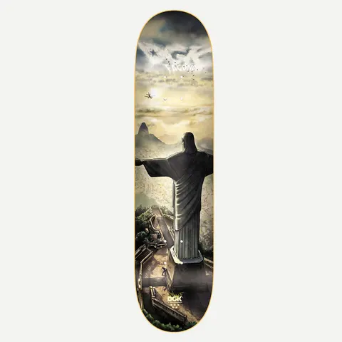 DGK Redeemer Fagundes 8.0 skateboard deck: Rear view of the Christ the Redeemer statue over Rio de Janeiro at sunrise, with Sugarloaf Mountain, hazy hills, a plane and a small skater on the steps below. Cloud lettering of DGK and the rider name sits at the top.