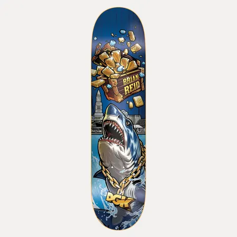 DGK Treasures Reid 8.06 skateboard deck: A great white shark wearing a gold DGK chain leaps from the water in front of a harbour skyline, below a bursting treasure chest of gold bars and diamonds labelled 'Brian Reid', on a blue board.