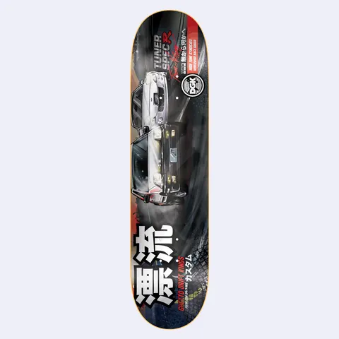 DGK Tuner Lenticular skateboard deck: Illustrated drift-racing scene of a white and a black Japanese sports saloon sliding side by side over tyre tracks, with large white kanji at the bottom, a DGK logo badge and 'Tuner Spec R' lettering.