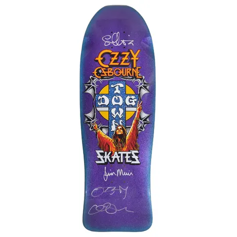 Dogtown Signed Limited Dogtown Ozzy Osbourne - x - Purple Flake / Blue Fade skateboard deck: Illustrated long-haired figure in an orange robe raising both arms in front of the Dogtown cross, flanked by bat wings, with gothic band-style lettering above and 'Skates' below, on a sparkly purple flake fading to blue at the rails. Several silver signatures added.