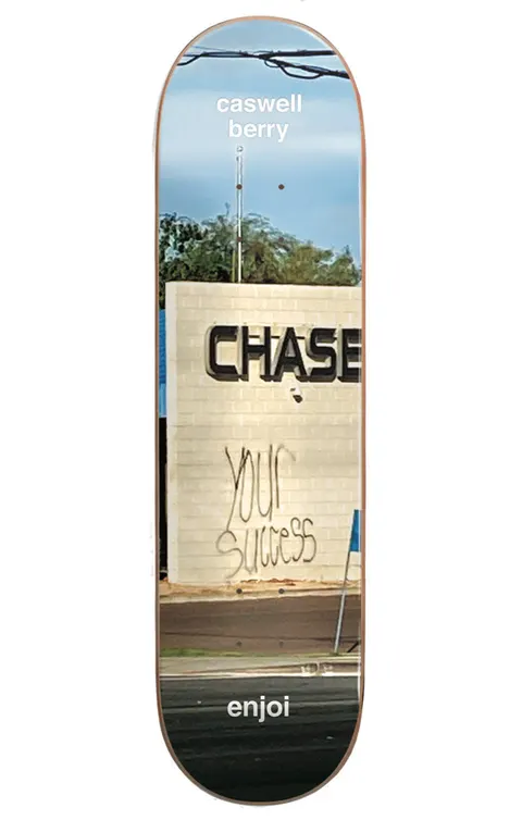 Enjoi Berry Tweaker R7 8.0 & 8.5 skateboard deck: Photograph of a Chase bank sign on a brick wall with 'your success' spray-painted below it, power lines and sky above. Caswell Berry name at the nose and enjoi at the tail.