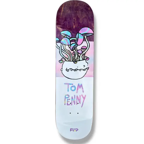 Flip Tom Penny Buddies 31.75 skateboard deck: Cartoon-style white bowl with a toothy grin sprouting long-stemmed psychedelic mushrooms with iridescent caps, over a pink and lilac gradient. Rider name in wobbly iridescent hand lettering on a pale lower half; purple stained wood at the top.