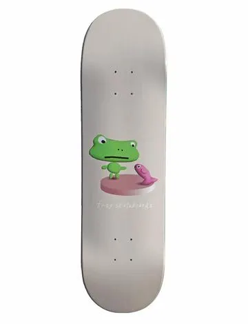 Frog Annoying Fish 8.6 skateboard deck: Pale grey deck with a small 3D-rendered cartoon green frog standing on a pink round platform, facing a small pink fish. Frog Skateboards is written in small white handwriting beneath.