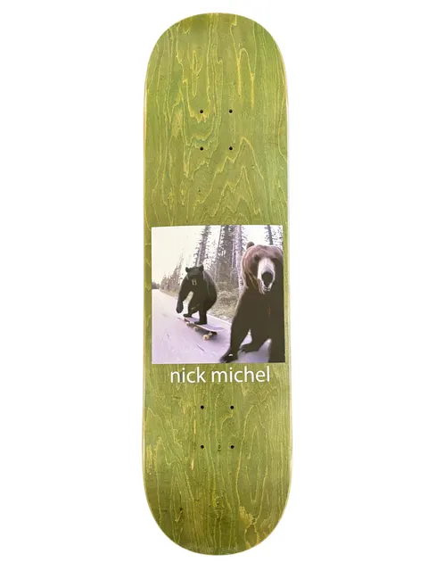 Frog Bears (Nick Michel) skateboard deck: A square photograph of two bears on a forest road, one riding a skateboard while a second runs up close to the camera, set on a green-stained wood deck. 'nick michel' is printed beneath in white.