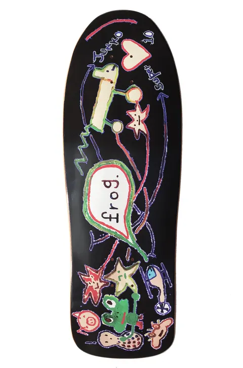 Frog Super Junko 10 skateboard deck: A childlike marker-style drawing on black: a heart, a dog on wheels, stars, a green frog, a peanut, a pig face and a helicopter, joined by looping arrows and a green speech bubble holding the word Frog. Old-school shape.