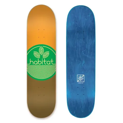 Habitat Leaf Dot Md skateboard deck: A green circle with a pale outline leaf-and-rings logo and the brand name across it, over a deck split orange above and brown below. The blue-stained underside is also shown.