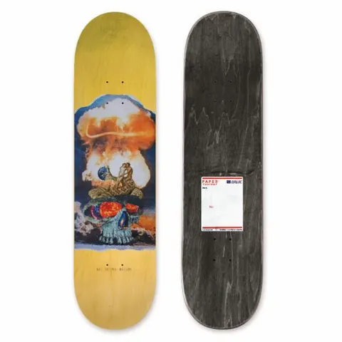 Habitat Paper Skaters Delatorre 8.125 skateboard deck: A collage of a mushroom cloud explosion over a skull with a glowing fiery brain, and a small couple embracing on the cloud. It sits on a yellow stained deck; a postal-label sticker is on the underside.