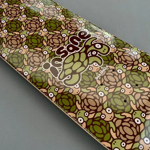 Insane Turtles skateboard deck: Repeating pattern of cartoon turtles with big round eyes in camouflage greens and browns, with a larger turtle and a bubble-lettered Insane logo at the centre.