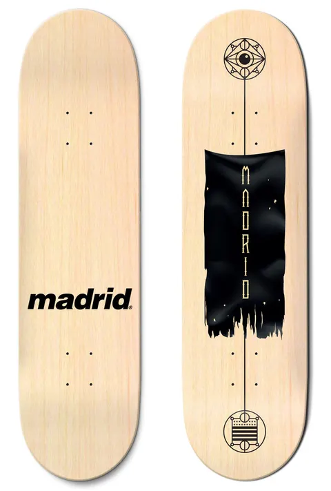 Madrid Battle Flag 8 skateboard deck: Natural wood deck with a torn black banner with vertical gold lettering, between two geometric emblems linked by a thin line, one topped with an eye. The other deck shows only the Madrid logo in black.