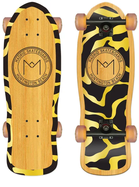 Madrid Harbor Series Shamini 25 skateboard deck: Bamboo-veneer cruiser shape shown top and bottom. A circular stamp-style Madrid Skateboards Huntington Beach logo sits mid-deck, with a black and gold abstract tiger-stripe pattern around the edges and across the underside.