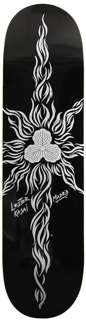 Madrid Lester Kasai 8 skateboard deck: Silver-white tribal-style flame design radiating from a central three-lobed emblem like a stylised sun on a black deck, with the rider's name handwritten and a Madrid logo to the side.