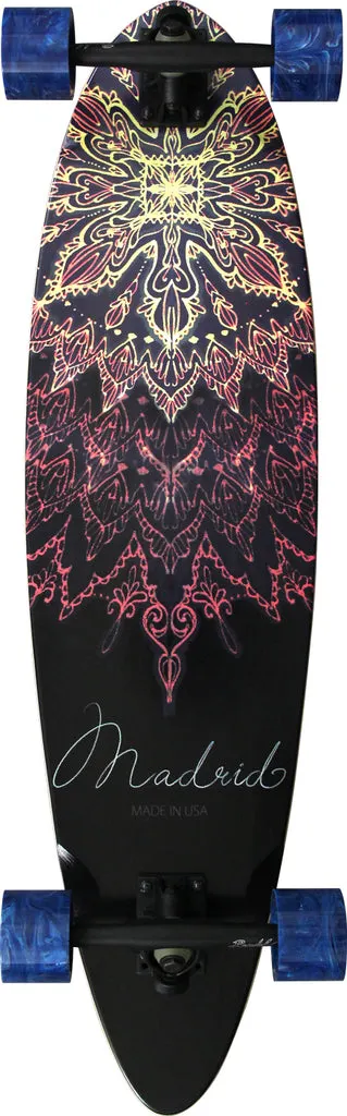Madrid Blunt 36.25 skateboard deck: Pintail longboard with a symmetrical mandala of fine ornate linework in yellow fading to pink and red on black, with the brand name in thin script and 'Made in USA' beneath. Shown as a complete with trucks and blue wheels.