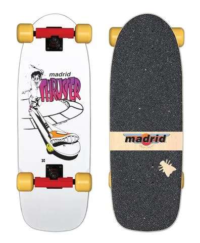 Madrid Thruster OG Cruiser skateboard deck: A white cruiser with a manga-style cartoon skater riding a curved ramp, with a big orange-and-white shoe in the foreground and Madrid Thruster lettering in pink gradient. Shown with red trucks and yellow wheels, and the gritty top with a Madrid label.