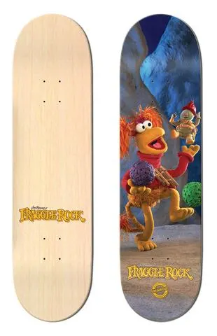 Madrid x Fraggle Rock Red 8 skateboard deck: A photographic image of Red Fraggle from Fraggle Rock juggling balls in a blue cave while a small Fraggle leaps overhead. Plain natural-wood deck shown beside it, with the Fraggle Rock logo at the tail.