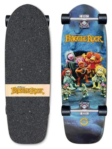 Madrid x Fraggle Rock Rock On Marty 29.25 skateboard deck: A photo of the Fraggle Rock puppet characters gathered at a cave mouth, one playing a guitar, with the orange Fraggle Rock logo above. Shown as a complete cruiser with the logo on a wood strip on the griptape.
