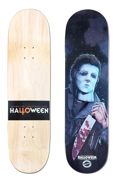 Madrid X Halloween - Boogeyman 8 skateboard deck: Illustrated portrait of a figure in a pale expressionless mask and dark coveralls holding a bloody kitchen knife, against a dark starry blue night. Underside has a black band reading Halloween 40 years.