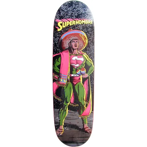 101 Gabriel Rodriguez Superhombre skateboard deck: Comic-style illustration of a Mexican take on a caped superhero, with a sombrero, pink serape, green suit, maracas and an S-shield on the chest, standing on a rocky ground under a speckled starry sky. Title in yellow lettering at the top.