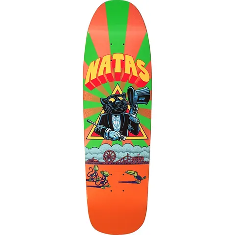 101 Natas Kaupas Zap cat skateboard deck: Black cat in a tuxedo and bow tie raising a top hat and holding a cane inside a yellow triangle, on a green and orange sunburst, with a seaside funfair and boardwalk below and two monkeys and a toucan on the orange ground.