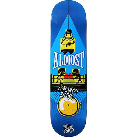 Almost Daewon Song Round Three skateboard deck: A cartoon boxing scene with a bowtied figure hanging at the top, two masked figures in red gloves in a ring, and a yellow bell at the bottom, on a blue deck.