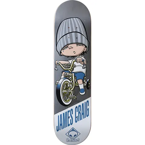 Blind James Craig Lowrida skateboard deck: A cartoon child in an oversized grey striped beanie, with sleepy eyes, rides a gold lowrider bicycle with stabilisers. The rider's name is printed in blue at the bottom with the Blind alien logo.