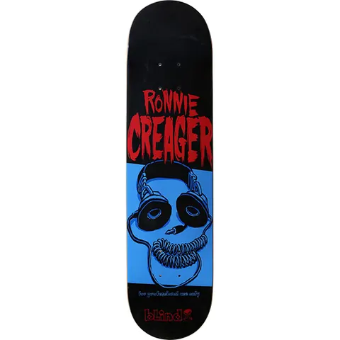 Blind Ronnie Creager Skullphonze skateboard deck: Blue skull wearing large headphones with the coiled cord forming its jaw, on a blue panel below the dripping red rider name on black. Small tagline above the Blind logo.