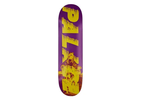 Palace Bankhead Purple 8.4 skateboard deck: Purple deck with large yellow Palace lettering with dripping edges running down its length, over a yellow-toned photograph of a figure in a fur-trimmed coat seated in front of a fire.